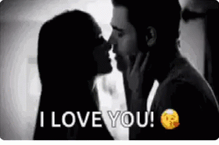 Man And Woman Kissing In Front Of Window GIF