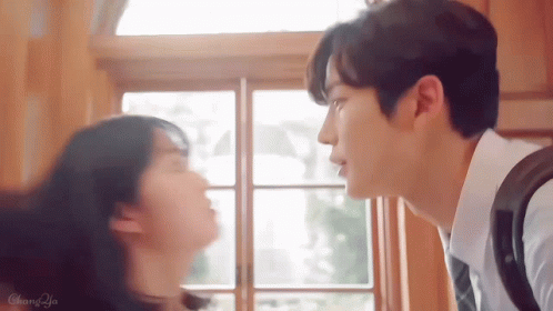 Man And Woman Kissing In Front Of Window GIF