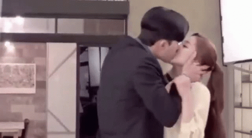 Man and Woman Kissing in Living Room
