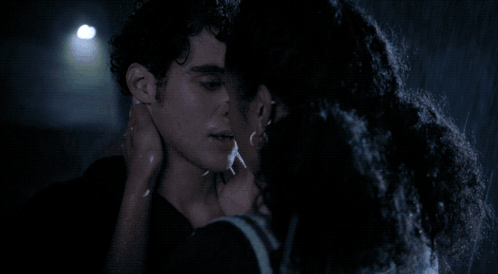 Man and Woman Kissing in Rain at Night