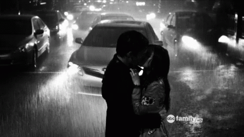 Man And Woman Kissing In Rain GIF