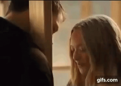 Man and Woman Kissing in Room