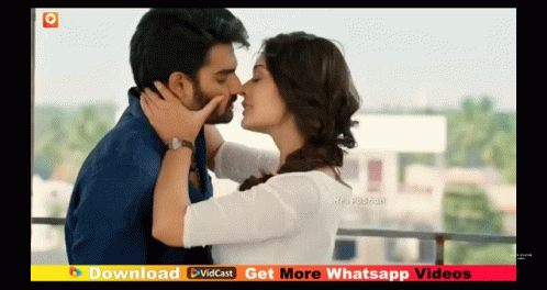 Man And Woman Kissing On Balcony GIF