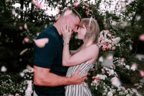 Man and Woman Kissing Under Falling Petals