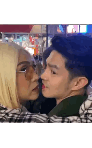 Man and Woman Kissing Woman Wearing Glasses