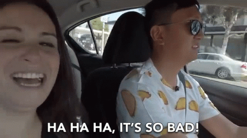 Man and Woman Laughing in Car With Tacos Shirt