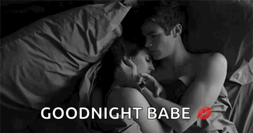 Man And Woman Laying In Bed Hugging And Kissing GIF