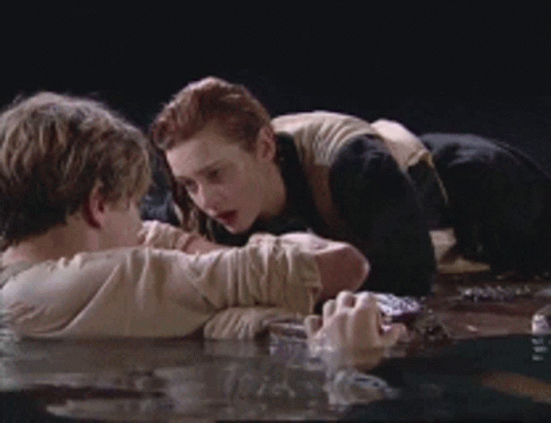 Man And Woman Laying In Water Looking At Each Other GIF