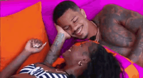 Man and Woman Laying Next to Each Other on Couch