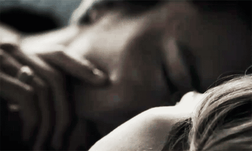 Man and Woman Laying on Bed Woman Touching His Neck