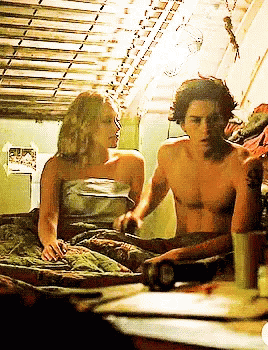Man And Woman Laying On Bed Woman Wrapped In Blanket GIF