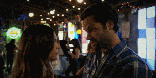 Man and Woman Looking at Each Other in Bar with 30