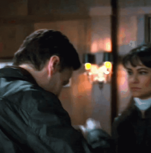 Man And Woman Looking At Each Other In Blurry Photo GIF