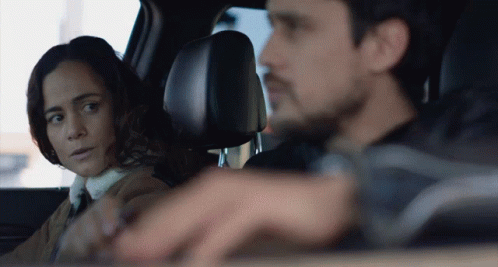 Man And Woman Looking At Each Other In Car GIF