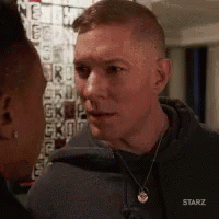 Man And Woman Looking At Each Other In Starz Hoodie GIF
