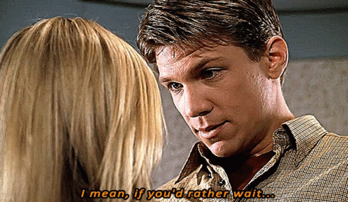 Man and Woman Looking at Each Other Saying I Mean If You'd Rather Wait