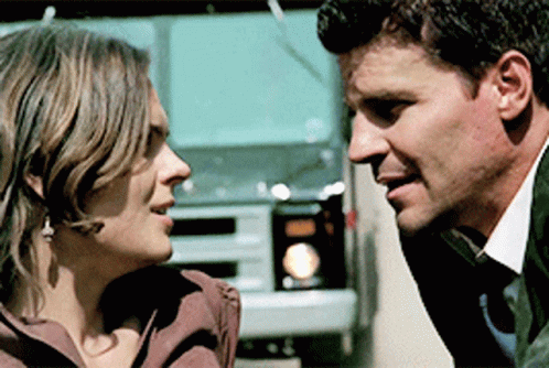 Man and Woman Looking at Each Other with Truck