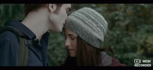 Man and Woman Looking at Each Other Woman in Knitted Hat