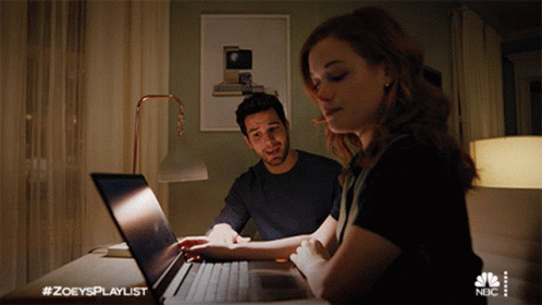 Man and Woman Looking at Laptop with #zoeysplaylist