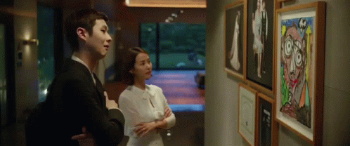 Man And Woman Looking At Painting GIF