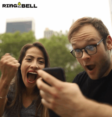 Man And Woman Looking At Phone Ring The Bell GIF
