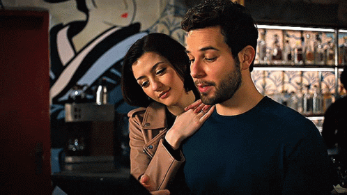 Man and Woman Looking at Tablet