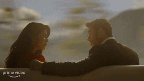 Man And Woman Looking Into Each Other's Eyes With Prime Video Logo GIF