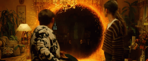 Man And Woman Looking Into Fire Portal GIF