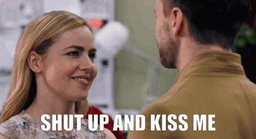 Man and Woman Looking With Shut Up and Kiss Me