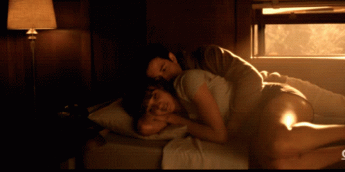 Man and Woman Lying on Bed with C