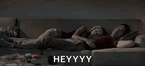 Man And Woman Lying On Couch Heyyy GIF