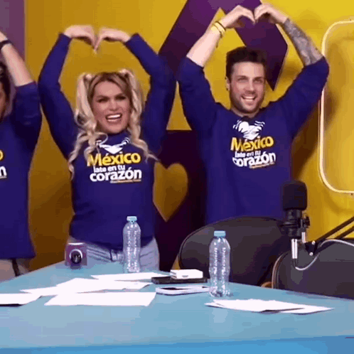 Man and Woman Making Heart Shape in Mexico Shirts