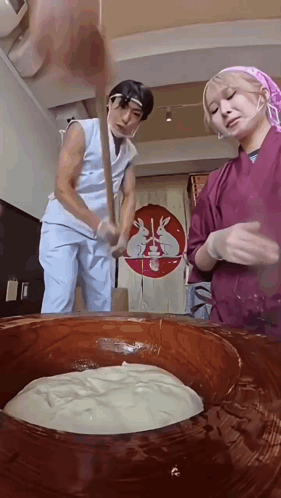 Man and Woman Mixing in Large Bowl