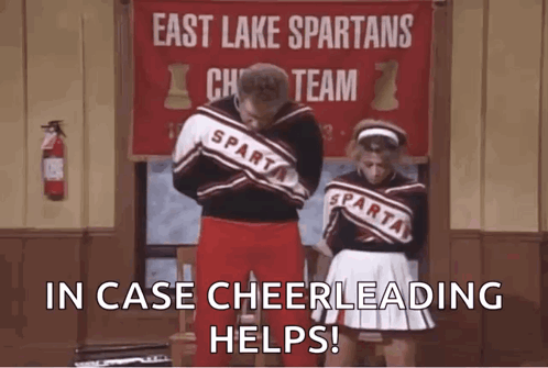 Man And Woman Next To East Lake Spartans Cheer Sign GIF
