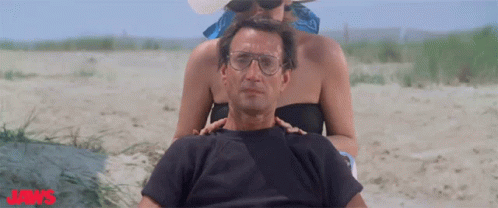 Man and Woman on Beach With Jaws