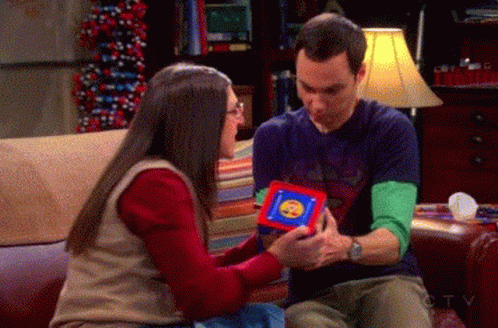 Man and Woman on Couch Man Holding Cube With Smiley Face