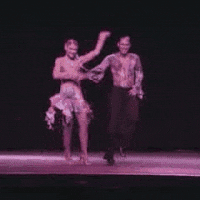Man And Woman Performing Salsa On Stage GIF