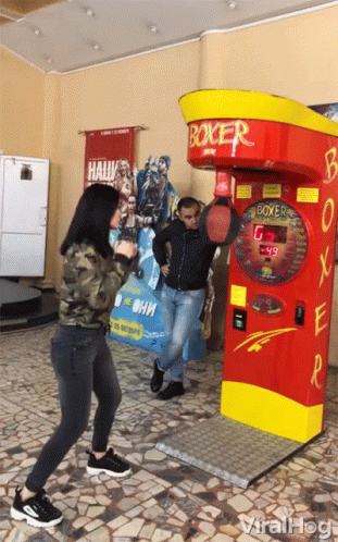 Man and Woman Playing Boxing Machine