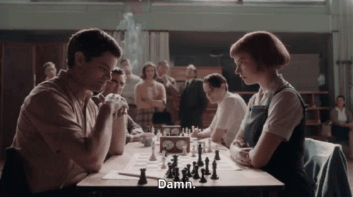 Man and Woman Playing Chess Woman Says Damn