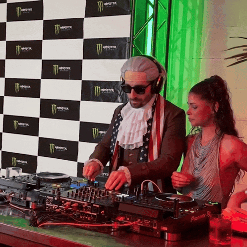 Man And Woman Playing Music In Front Of Monster Backdrop GIF