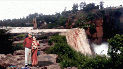 Man And Woman Posing By Waterfall GIF