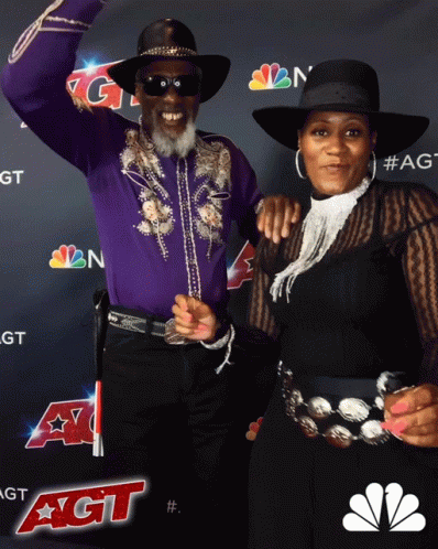 Man and Woman Posing in Front of NBC Logo