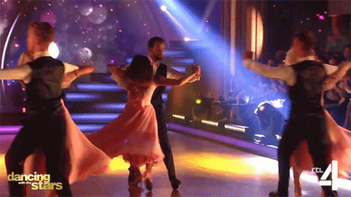 Man And Woman Posing With Disco Ball GIF