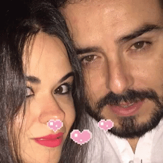 Man and Woman Posing With Pink Hearts on Faces