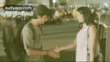 Man and Woman Shaking Hands at Night
