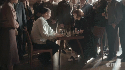 Man And Woman Shaking Hands Before Crowd With Netflix Logo GIF
