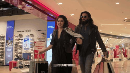 Man And Woman Shopping Weekend Offer GIF