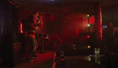 Man and Woman Singing Into Microphones