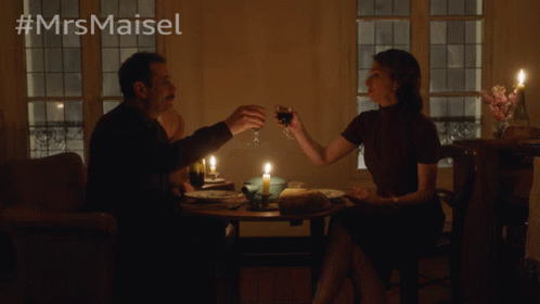 Man and Woman Sitting at Candlelit Table