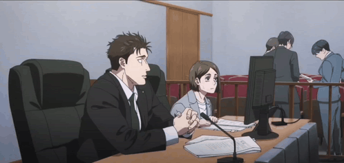 Man and Woman Sitting at Desk
